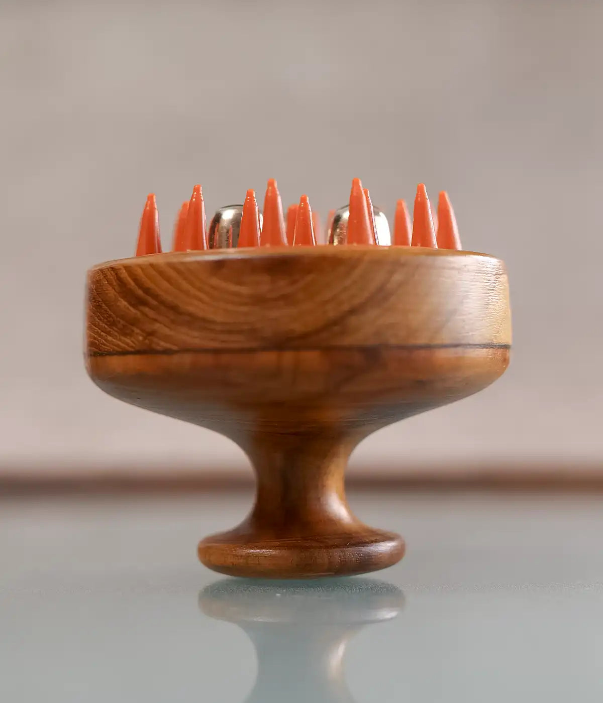 Image of Wooden kansa scalp massager with orange bristles